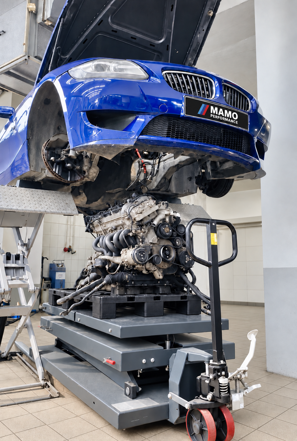 BMW raised on a lift with its engine removed for major repair
